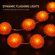 Close-up of glowing orange marigold flower string lights